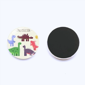 Detailed view of the front cartoon dinosaur design and the back magnetic base of the sticker