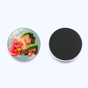 Detail of round 25mm glass fridge magnet featuring a red cartoon dragon illustration