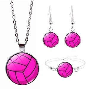 Detail of volleyball jewelry set with pink ball motif on necklace, earrings and bracelet