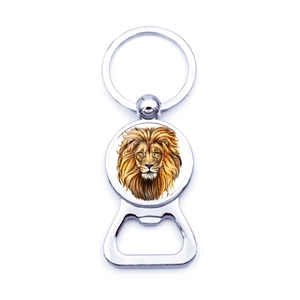 Detail of metal keychain bottle opener featuring a lion head art design in center