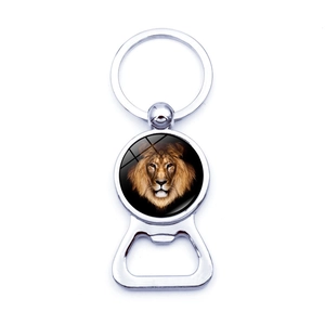 Detail of metal bottle opener keychain featuring a realistic lion head glass dome pendant