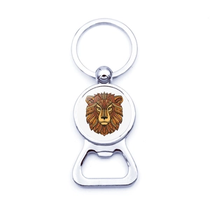 Close-up of metal bottle opener keychain with artistic lion mandala gemstone pattern