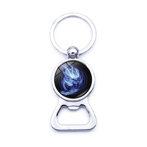 Detailed view of metal lion keychain bottle opener with blue fire graphic glass dome