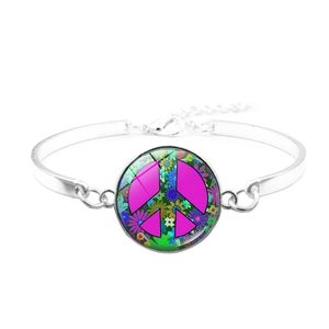 Detail of silver bangle bracelet featuring a colorful hippie peace sign glass cabochon