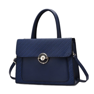 Navy blue luxury tote bag with embossed textures and a round metallic lock for women