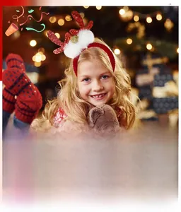 Close-up of sparkling red sequined antlers with white pom-poms on a festive headband