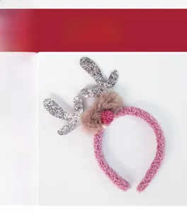 Detailed close-up of pink plush headband featuring silver sequin reindeer antlers