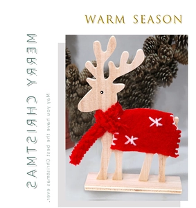 Close-up of wooden Christmas reindeer with red felt embroidery and knitted scarf
