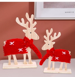 Detailed view of wooden Christmas reindeer with red felt capes and knitted scarves