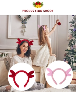 Detail of plush reindeer antler headband in red and pink for Christmas party costumes