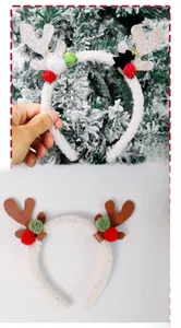 Detail of Christmas reindeer antler headbands with plush balls and bow decorations
