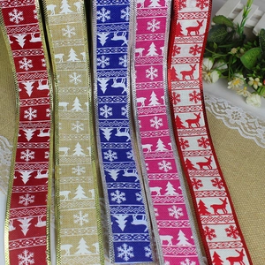 Vertical view of Christmas ribbons with reindeer and snowflake patterns and wired edges