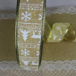 Detail of Christmas burlap ribbon with gold edges and festive reindeer snowflake prints