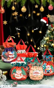 Detail of Christmas gift bags featuring snowman and reindeer prints with drawstrings