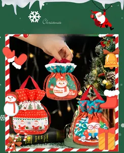 Close-up of Christmas velvet drawstring gift bags with Santa and Snowman prints