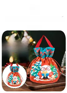 Detailed view of Christmas gift bag with Santa and reindeer prints, sized 27cm x 12cm