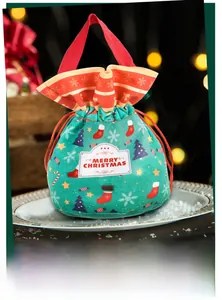 Detail of Christmas drawstring gift bag with velvet texture and festive patterns