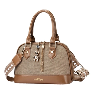 Brown patchwork canvas handbag with bear pendant and wide geometric shoulder strap