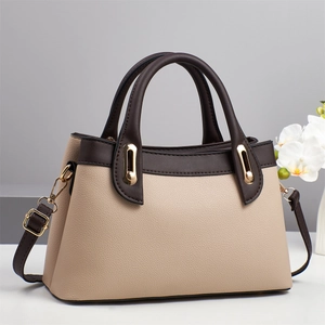 Close-up of litchi grain texture and gold hardware on beige crossbody tote bag