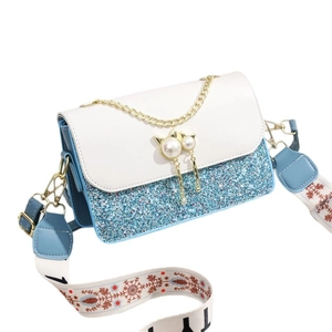 Blue and white sequined crossbody bag with wide floral strap and pearl cat ear charm