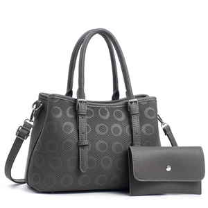 Detail of grey embossed tote bag with matching wallet and adjustable silver buckles