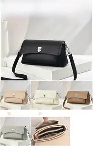 Detailed view of women's crossbody bag with multiple compartments and twist lock mechanism