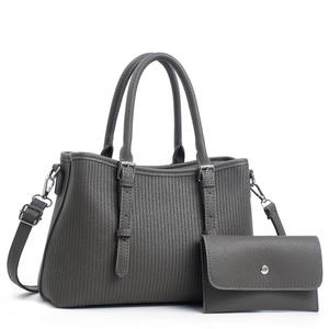 Close-up of grey textured leather tote bag set with matching wallet and silver hardware