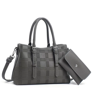 Detail of grey embossed lattice tote bag set with textured leather and silver hardware
