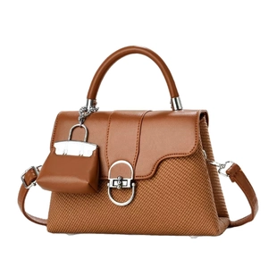 Brown leather and woven crossbody bag with silver buckle and mini bag pendant