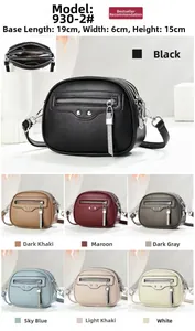 Close-up of triple-zipper leather crossbody bag with tassel detail and size specifications