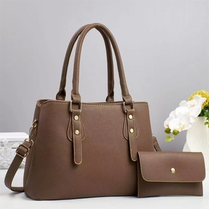 Close-up of brown litchi pattern leather tote bag and matching long flap wallet with gold hardware