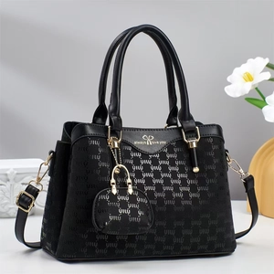 Black fashion tote bag with gold hardware, letter texture, and detachable shoulder strap