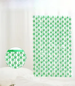 Close-up of green snowflake foil curtain backdrop for Christmas party wall decoration