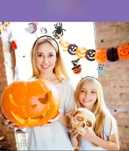 Adult and child wearing Halloween felt headbands with pumpkin and ghost spring decor