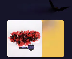 Detailed view of Halloween pumpkin garland on a scale showing 166.6g weight and PPT material