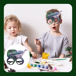 Kids wearing dinosaur party paper glasses with Jurassic Age text in an art scene