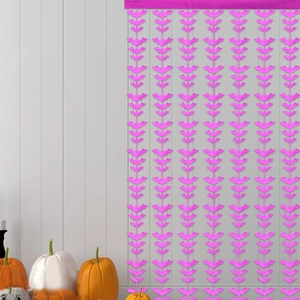 Pink bat foil fringe curtain for Halloween party decor shown against a grey wall