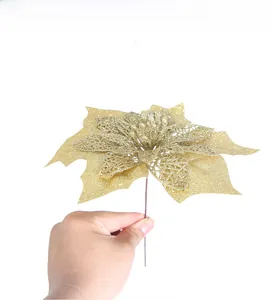 Close-up of artificial gold glitter poinsettia flower for Christmas tree decoration