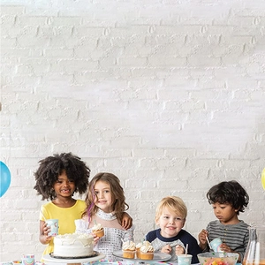 Detailed white brick wall backdrop texture for professional birthday photography setup