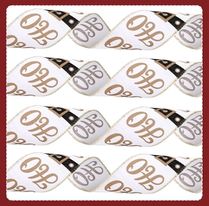 Detail of white Christmas ribbon with gold HOHO print and metallic stitched edges