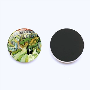 Detail view showing the artistic front and flexible magnetic back of the round fridge magnet