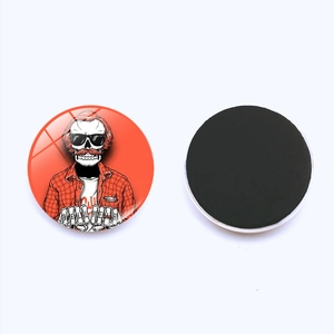 Detail of 25mm round skull glass magnet with HELL YEAH graphic and magnetic back