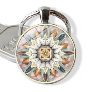 Macro view of mandala pattern keychain with glass dome and polished silver metal ring