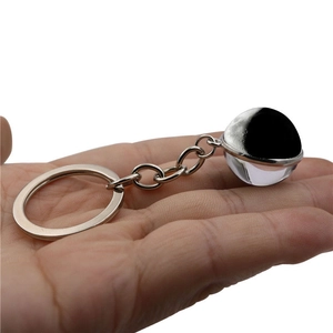 Double-sided glass moon ball keychain with silver metal ring and crescent moon pendant