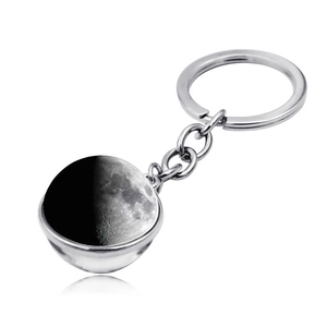 Detail of double-sided glass moon ball keychain with realistic lunar surface texture
