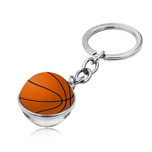 Macro view of a basketball keychain with a silver metal frame and a glossy orange dome charm
