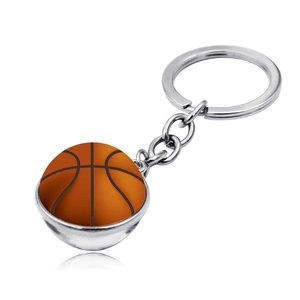 Detailed view of the double-sided glass basketball pendant with silver metal keychain ring