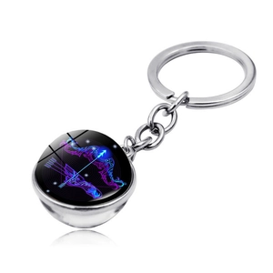 Detailed macro view of Sagittarius glass orb keychain with silver metal finish
