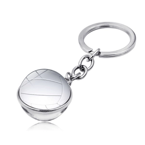 Macro detail of volleyball glass ball keychain with polished finish on a white background
