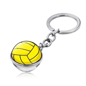 Detail of volleyball glass dome keychain featuring yellow ball pattern and silver metal ring